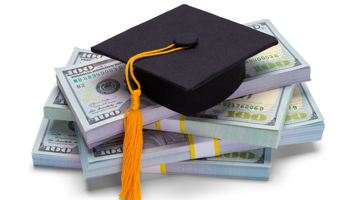 college graudation cap on a pile of money