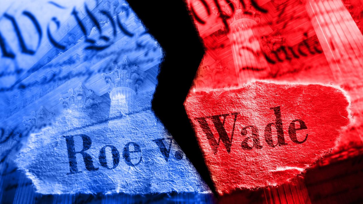 Constitution and Roe v. Wade headline torn into red and blue halves