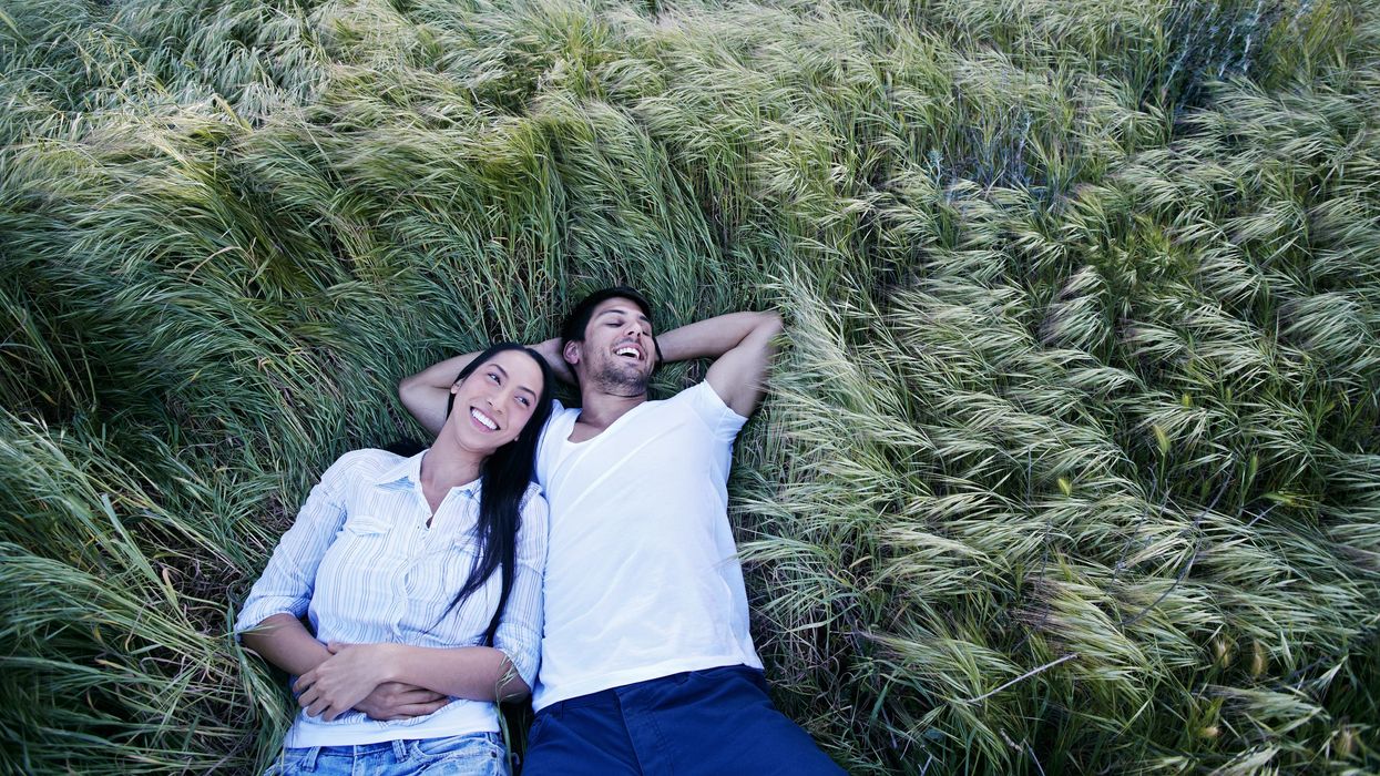 Couple lying in tall grass