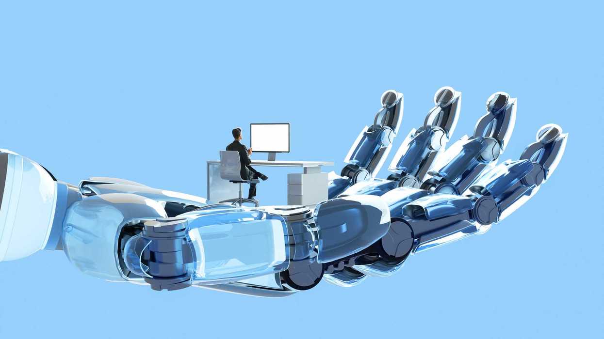 Digital illustration of robot's hand holding and supporting man who is working on his desk using computer, represent themes of artificial intelligence (AI), the future of work, and the intersection of humanity and technology.