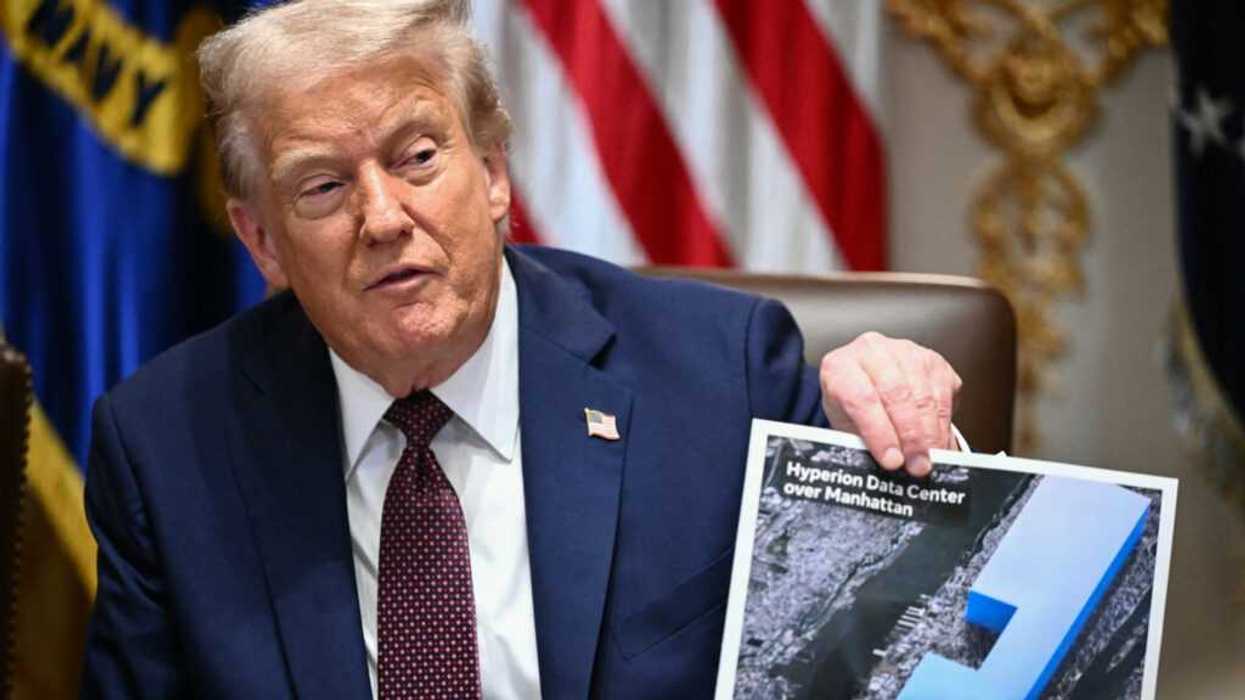Donald Trump holding a picture