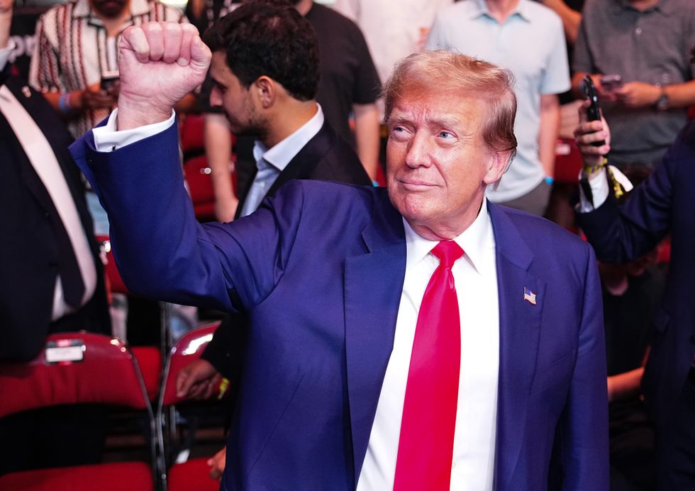 donald trump holds up a fist