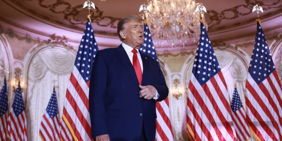 donald trump surrounded by American flags