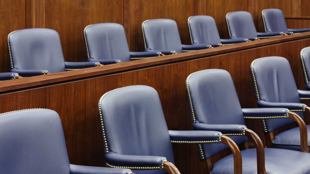 Empty jury seats in a courtroom.