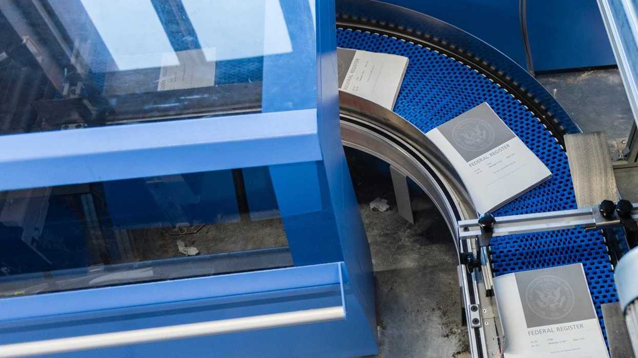 Federal Register Reports being printed out of a large machine.