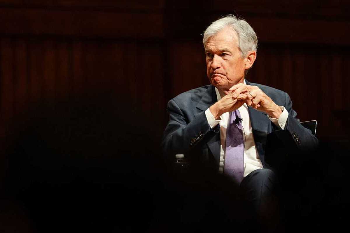 Federal Reserve Chairman Jerome Powell sitting with his hands folded in front of him.