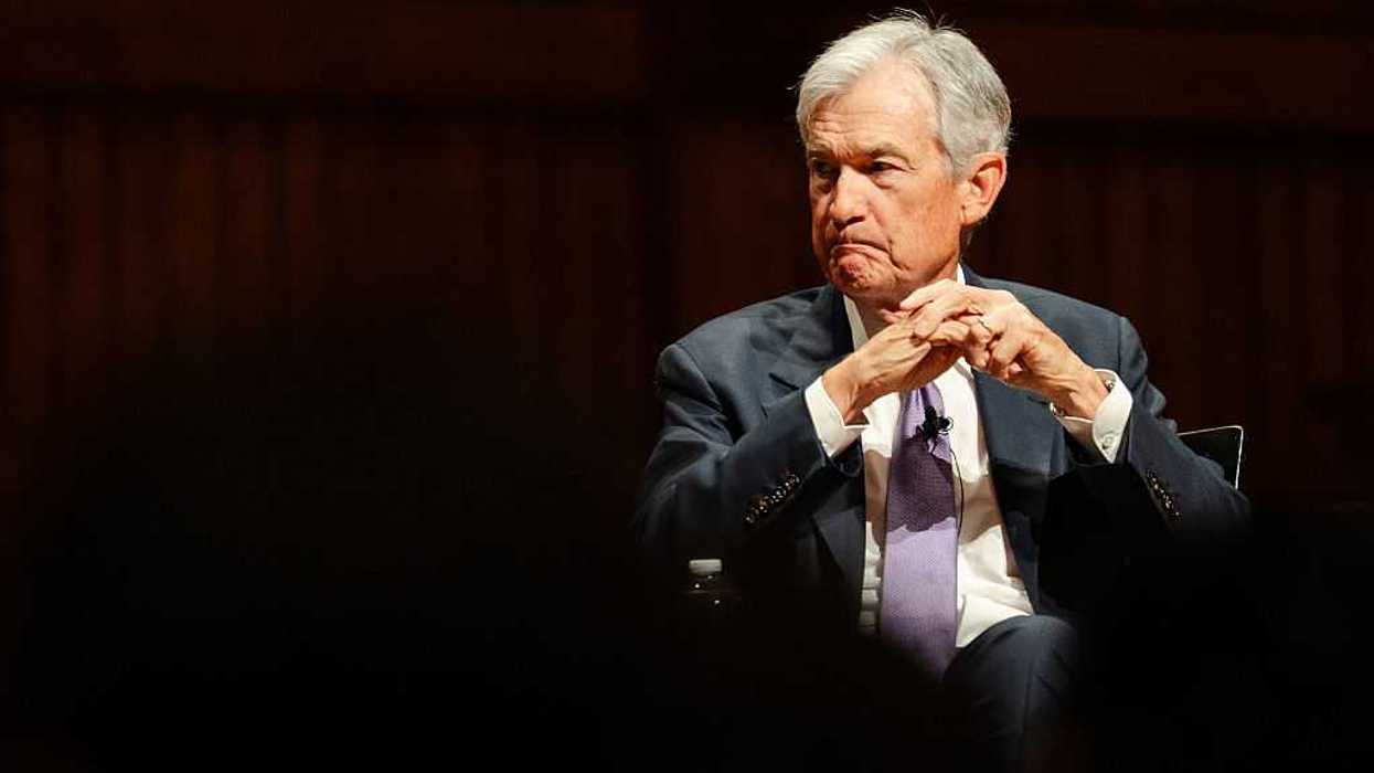 Federal Reserve Chairman Jerome Powell sitting with his hands folded in front of him.