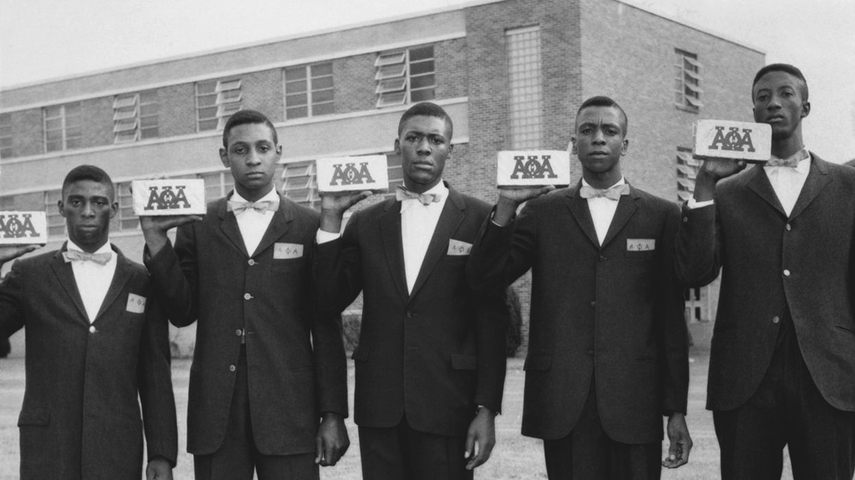 Five Black men holding their Alpha Phi Alpha cards