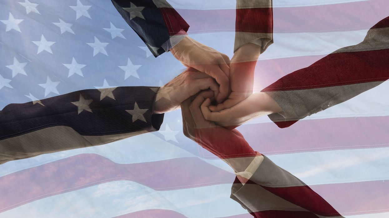 Five hands coming together with the American Flag.