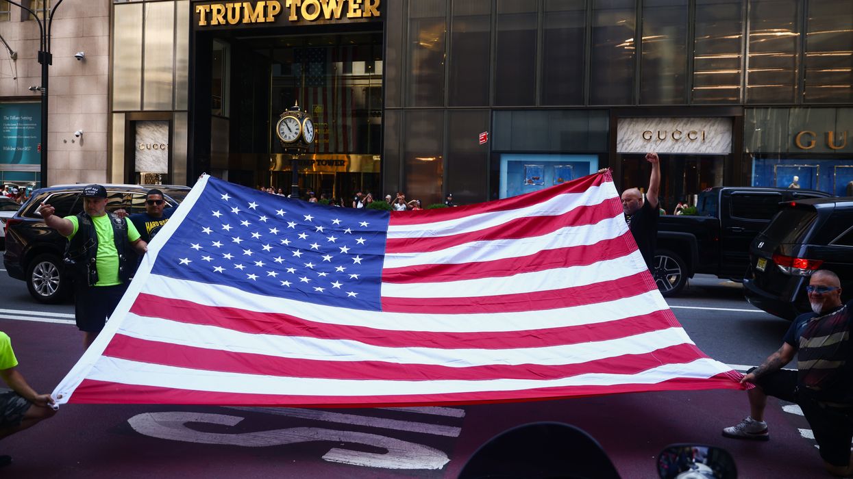 Flag being held out in front of Trump tower