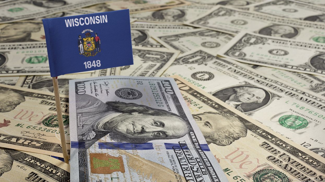 Flag of Wisconsin sticking in a variety of American banknotes