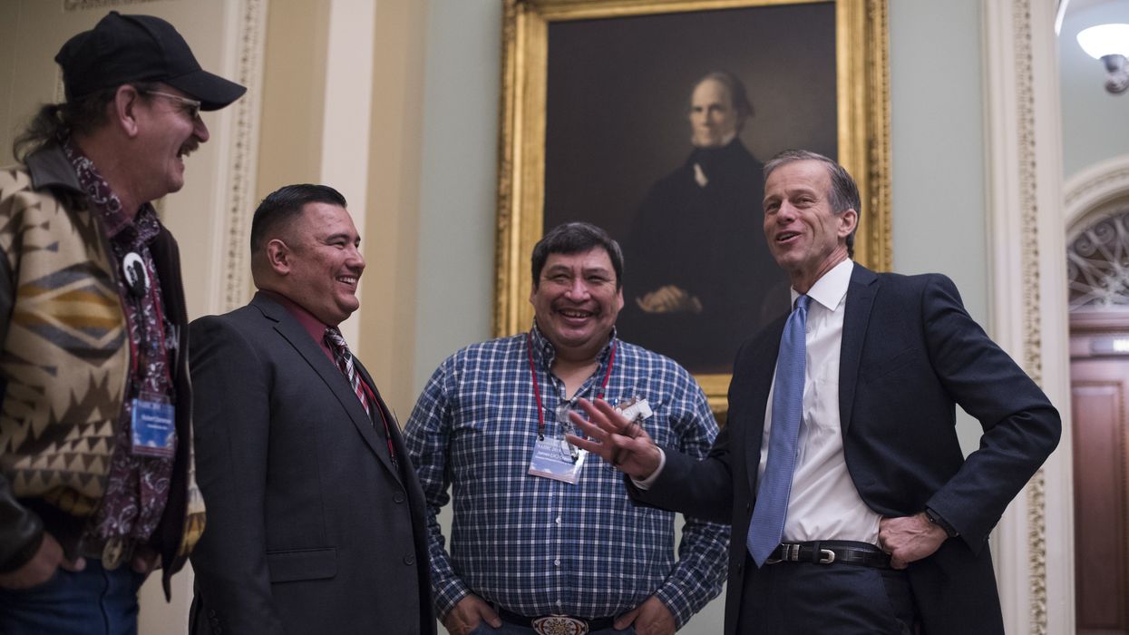 Four men having a conversation