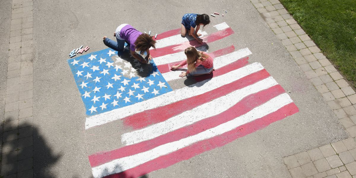 Girls drawing an American flag with chalk