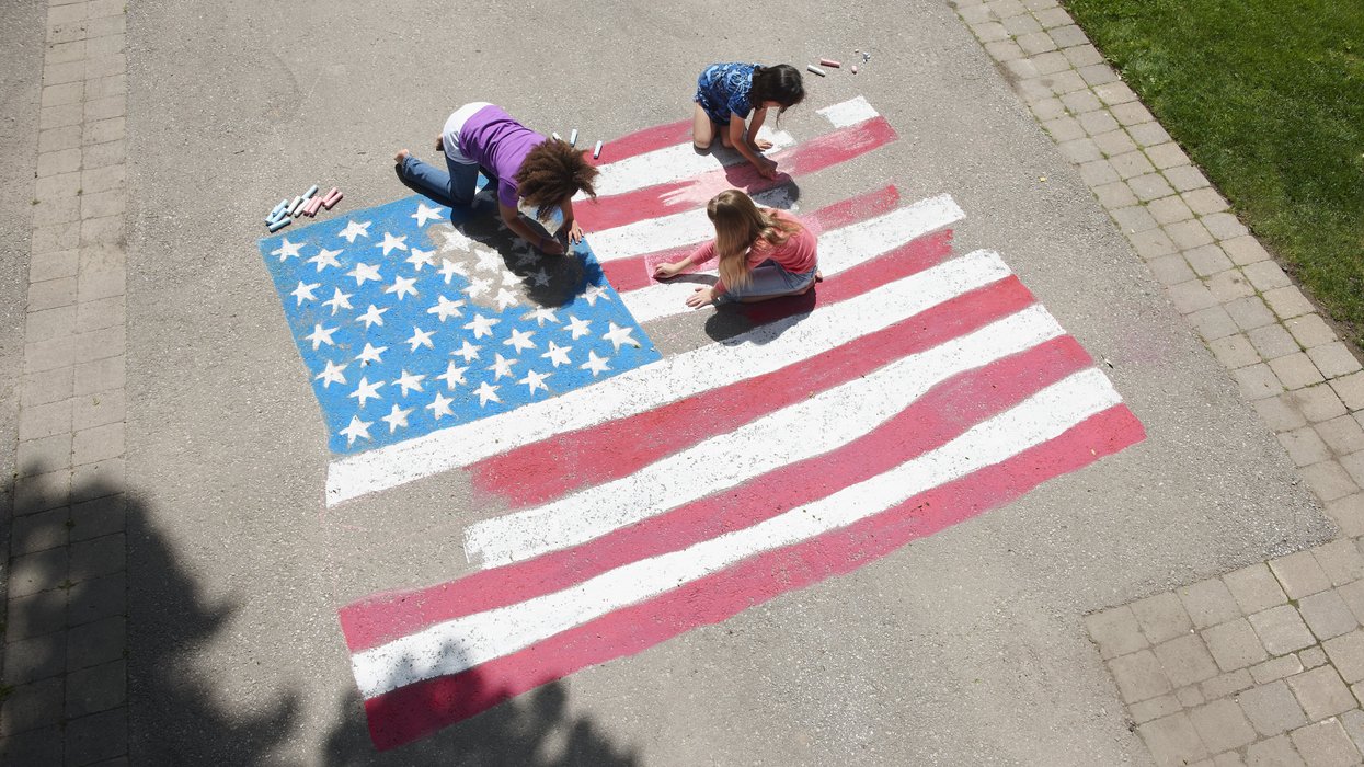 Girls drawing an American flag with chalk