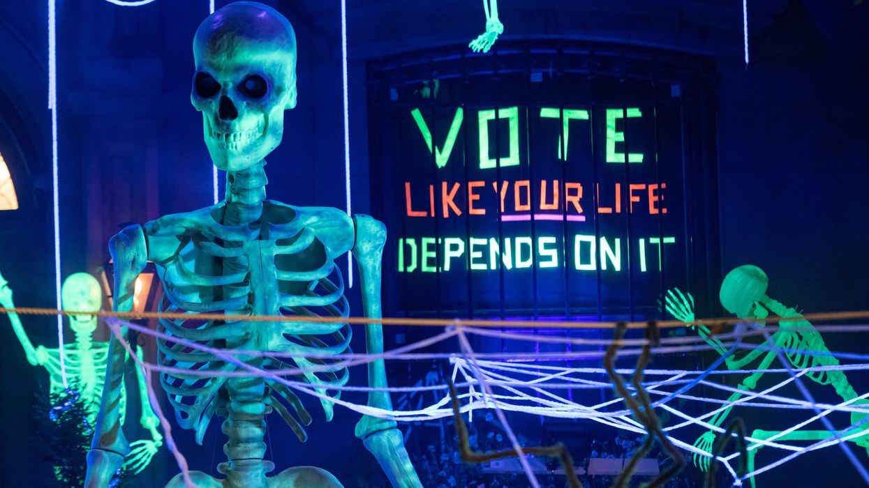 Halloween decorations with a sign that reads "Vote like your life depends on it"