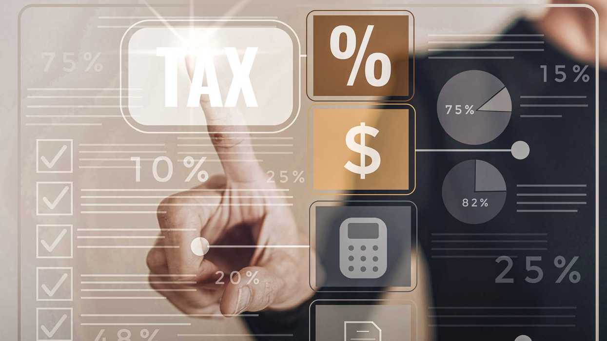 Hand points to the word tax on a screen