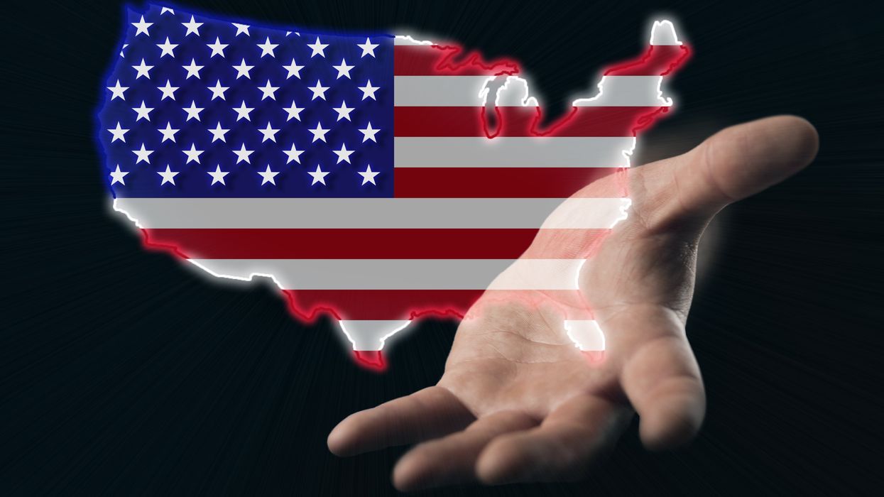 hand reaching out over an American flag
