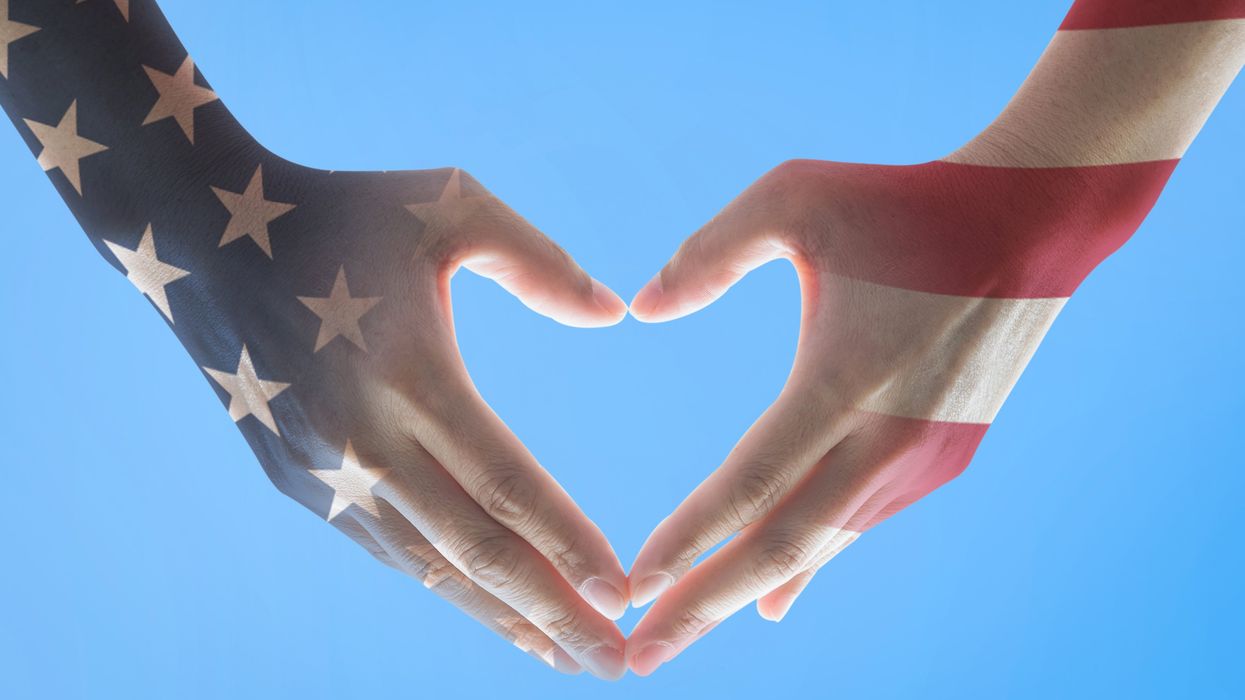 Hands making a heart and painted to look like an American flag