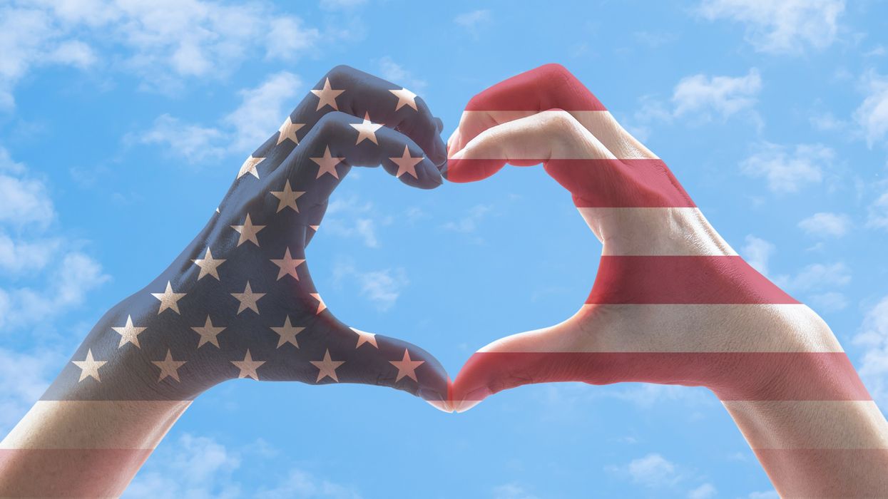 Hands painted like an American flag and making the shape of a heart