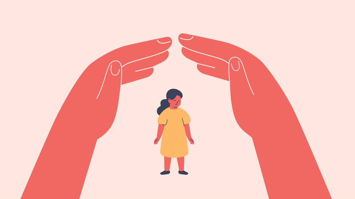 Hands protecting a child.