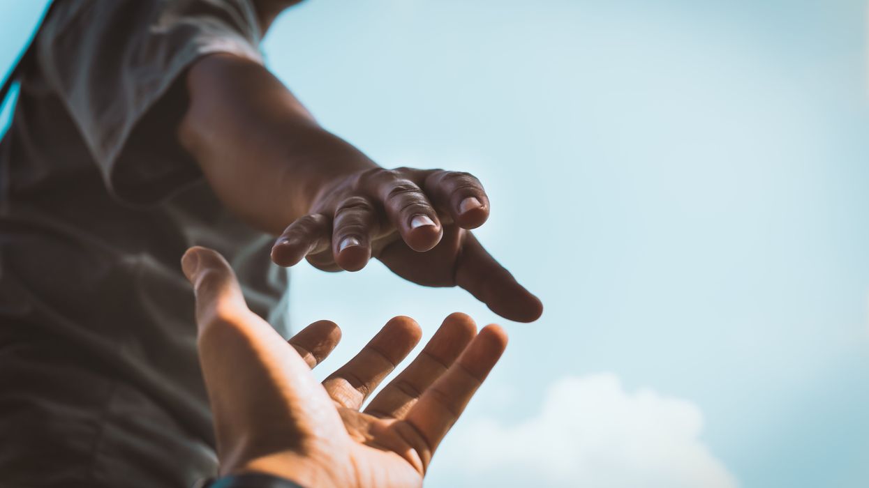 Hands reaching for each other