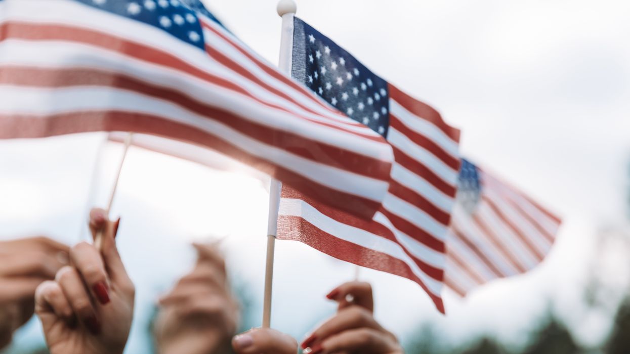 Hands waving small American flags