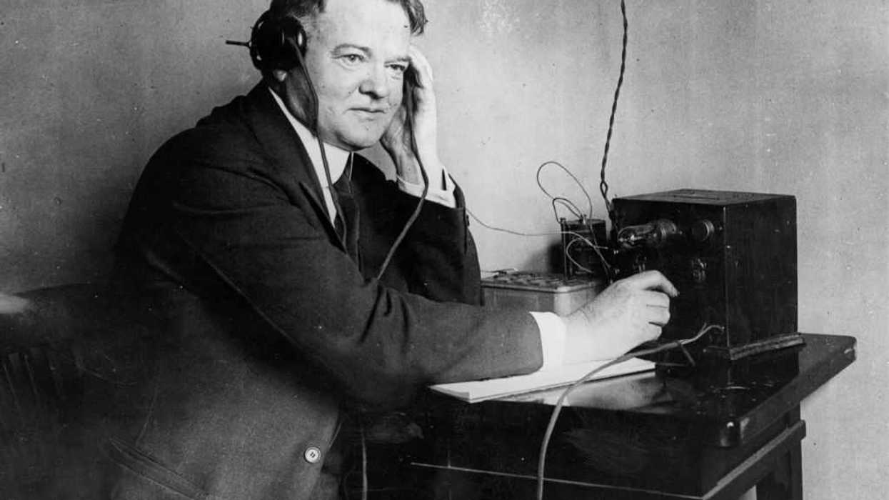 Herbert Hoover listening to a one valve radio set.