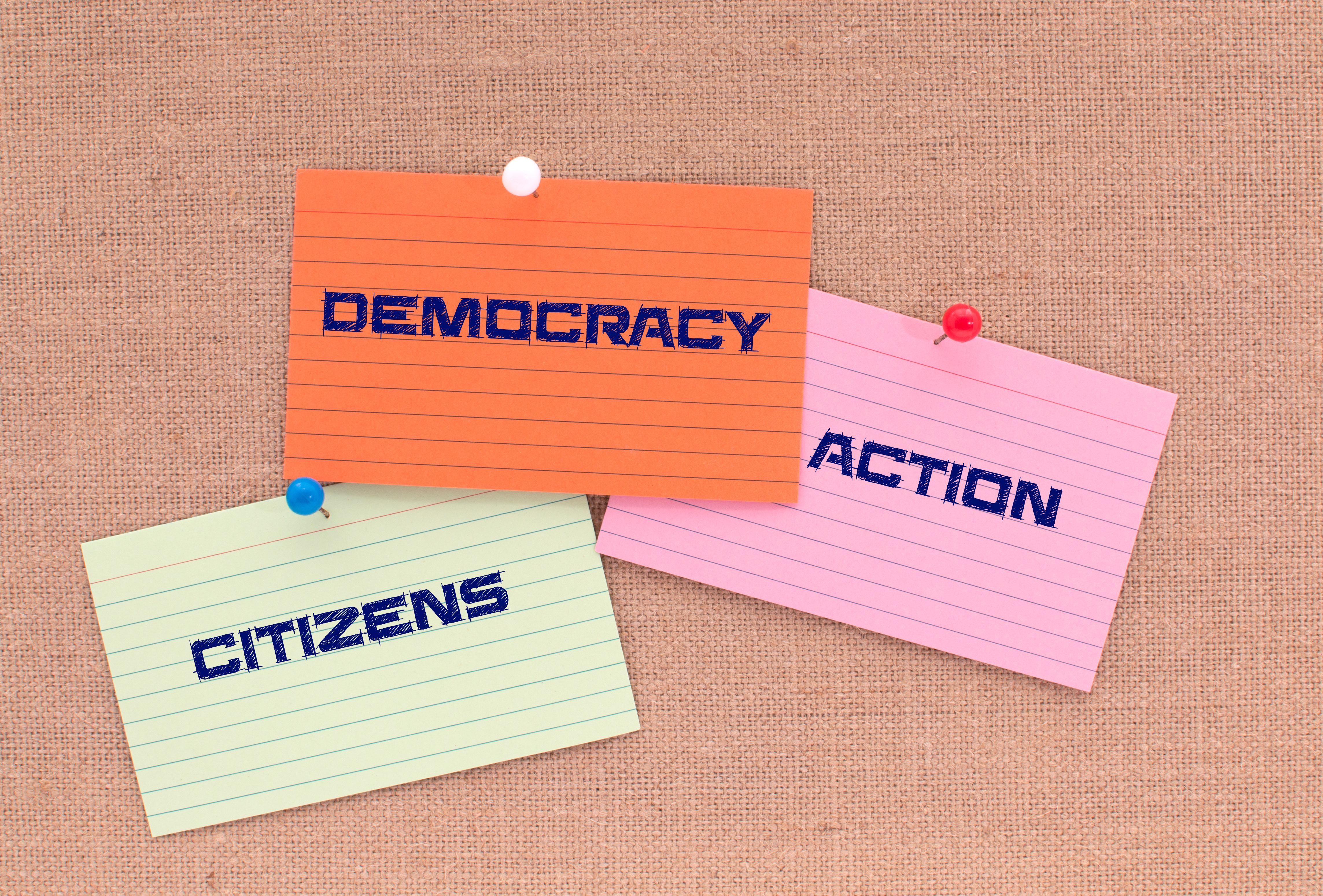 Notecards saying "democracy," "citizens" and "action"