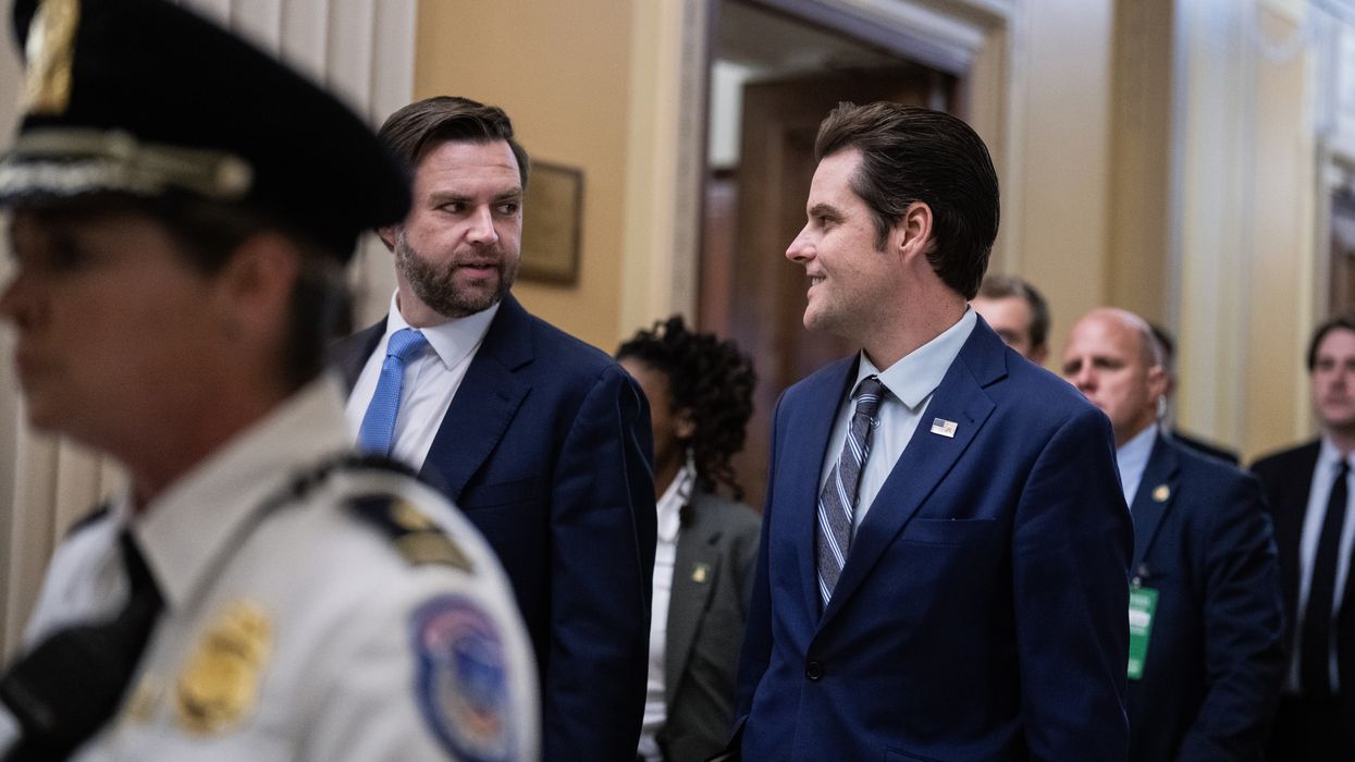 J.D. Vance and Matt Gaetz talking to each while walking