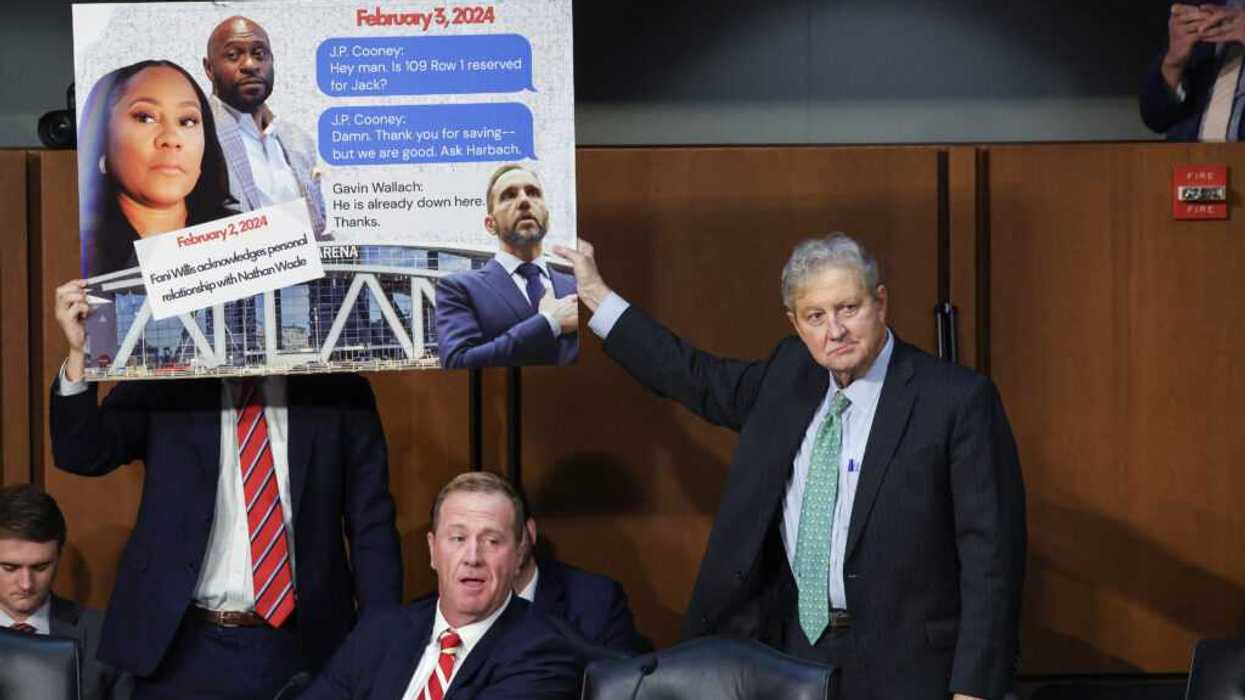 John Kennedy display a sign