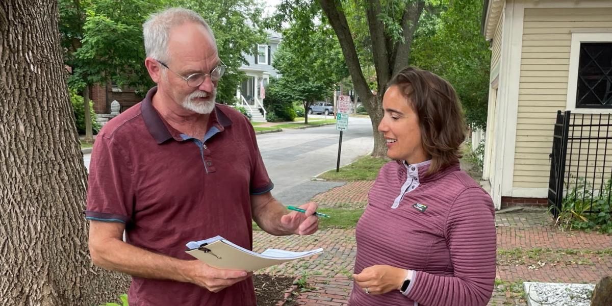 ​Kaitlin LaCasse collects petition signatures in Raymond, Maine.