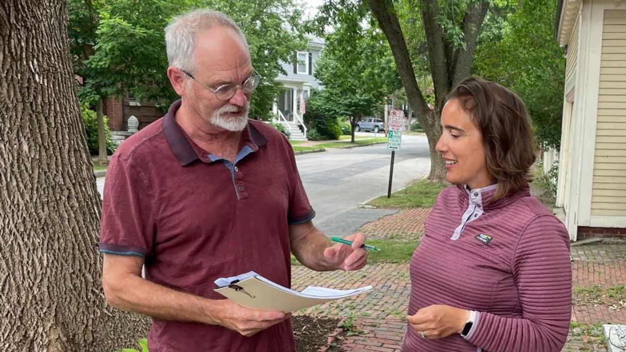 Kaitlin LaCasse collects petition signatures in Raymond, Maine.