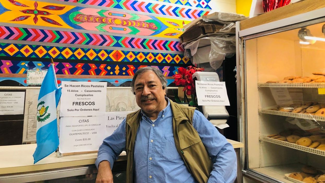Latino man standing at the counter in a bakery