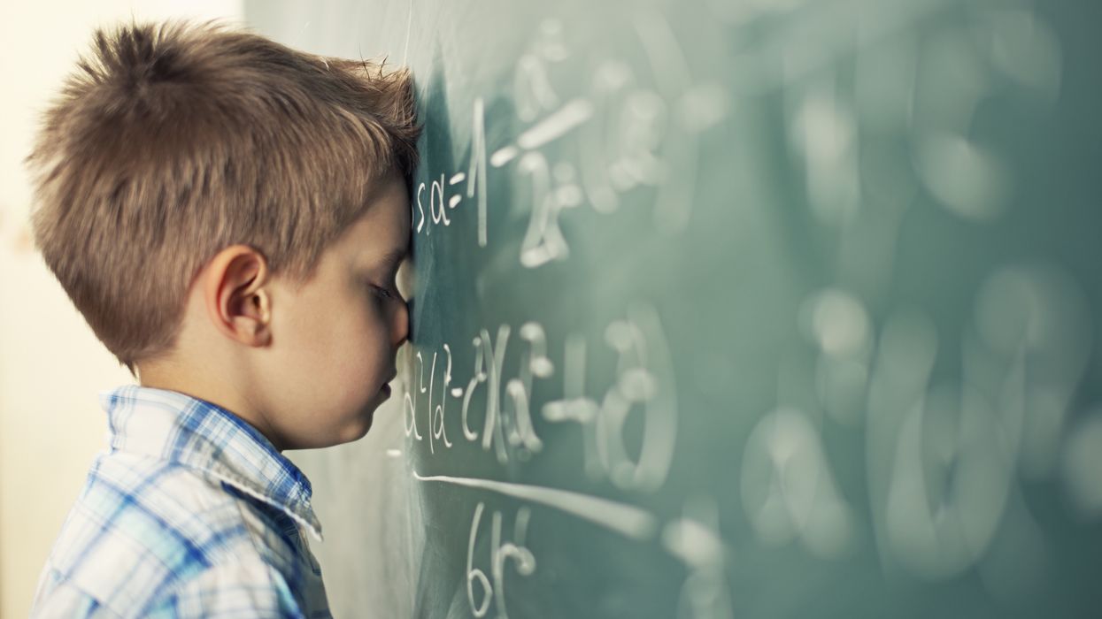 Little boy in math class overwhelmed by the math formula