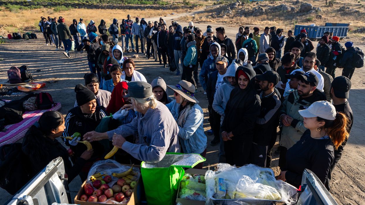 Long lines of people receiving food
