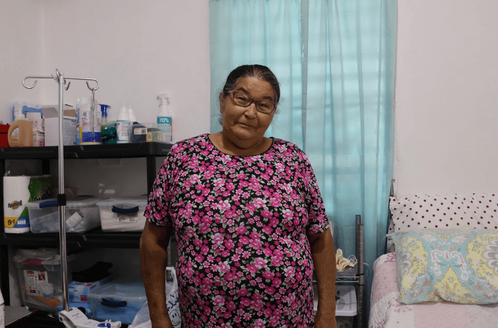 Luz Mar\u00eda Torres Sierra stands in her bedroom in Adjuntas