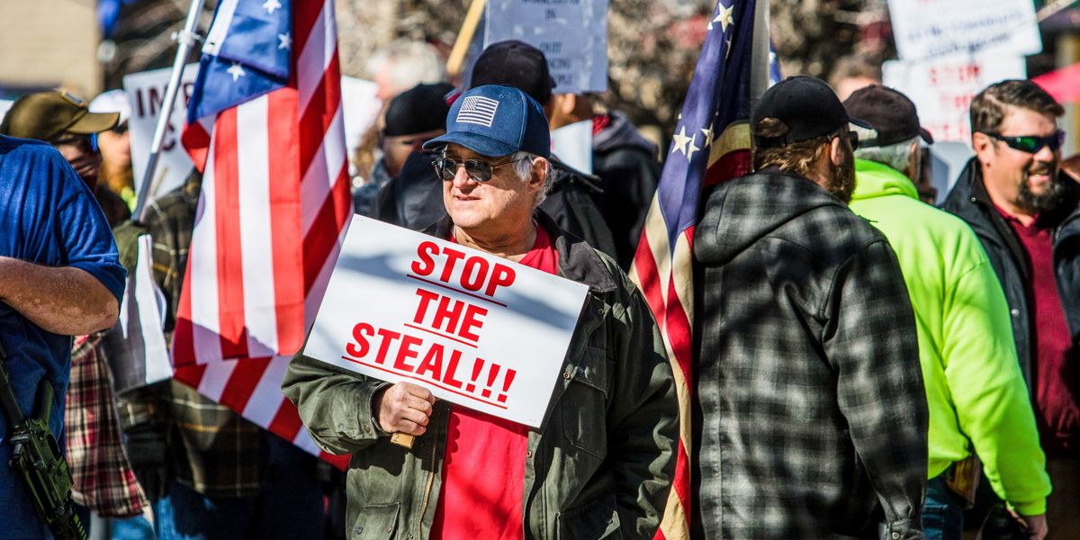 Man holding a "Stop the Steal" sign