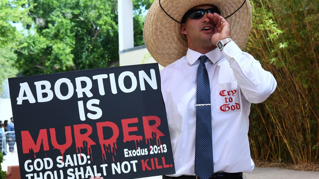 Man holding an anti-abortion sign