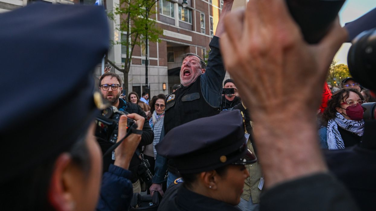 Man in a crowd yelling at police