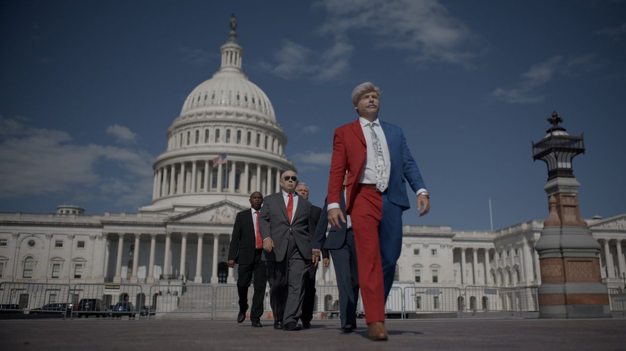 Man in red and blue outfit walking in front of the Capitol.