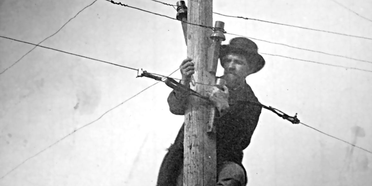 Man maintaining telegraph wire