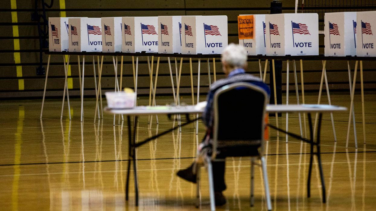 Man sitting in a chair near voting stations