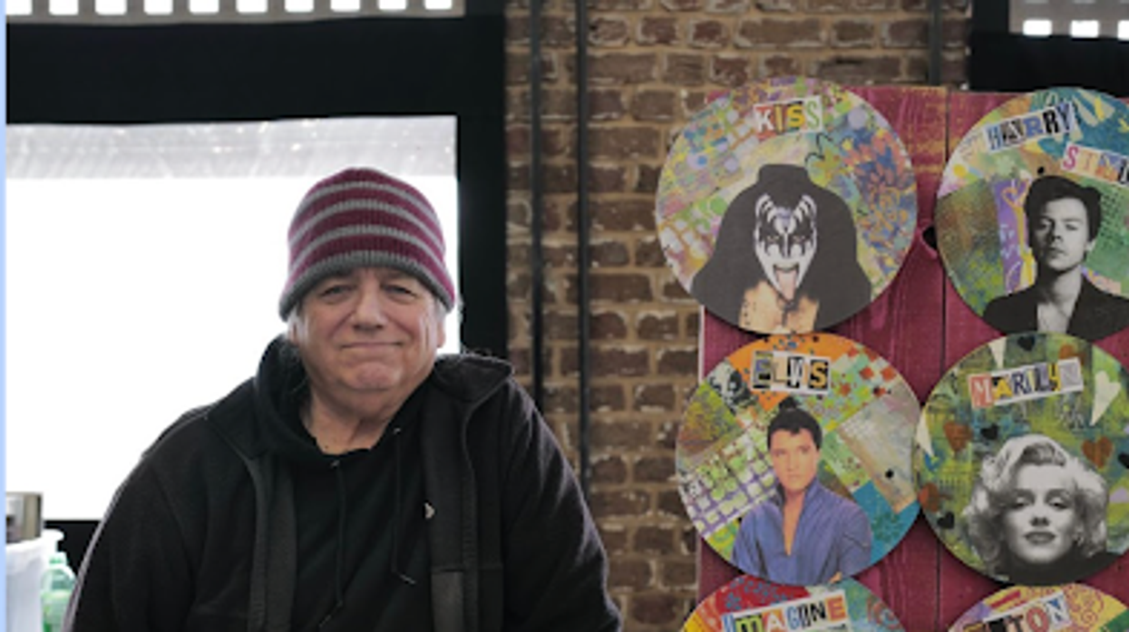 Man standing next to vinyl artwork