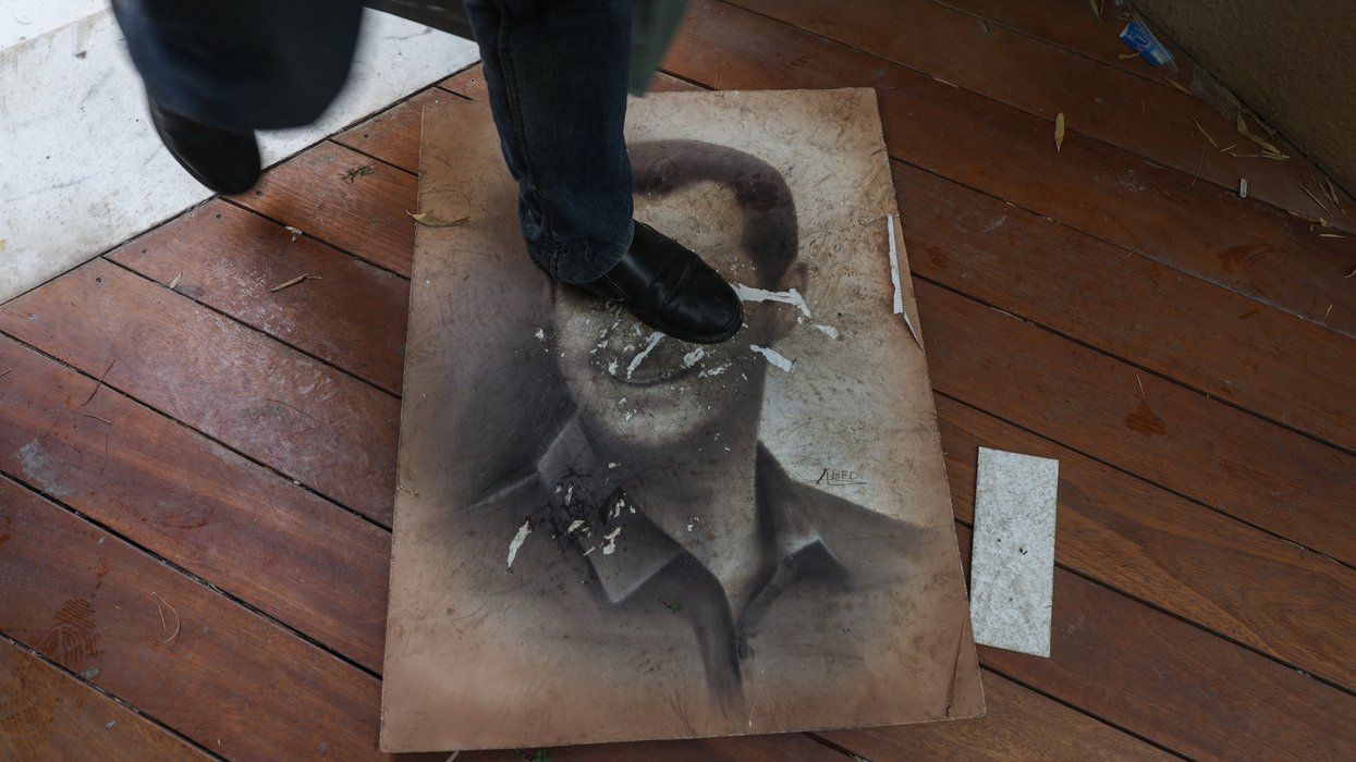 Man stepping on ripped poster