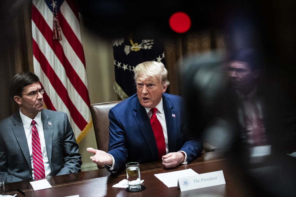 Mark Esper sitting next to Donald Trump