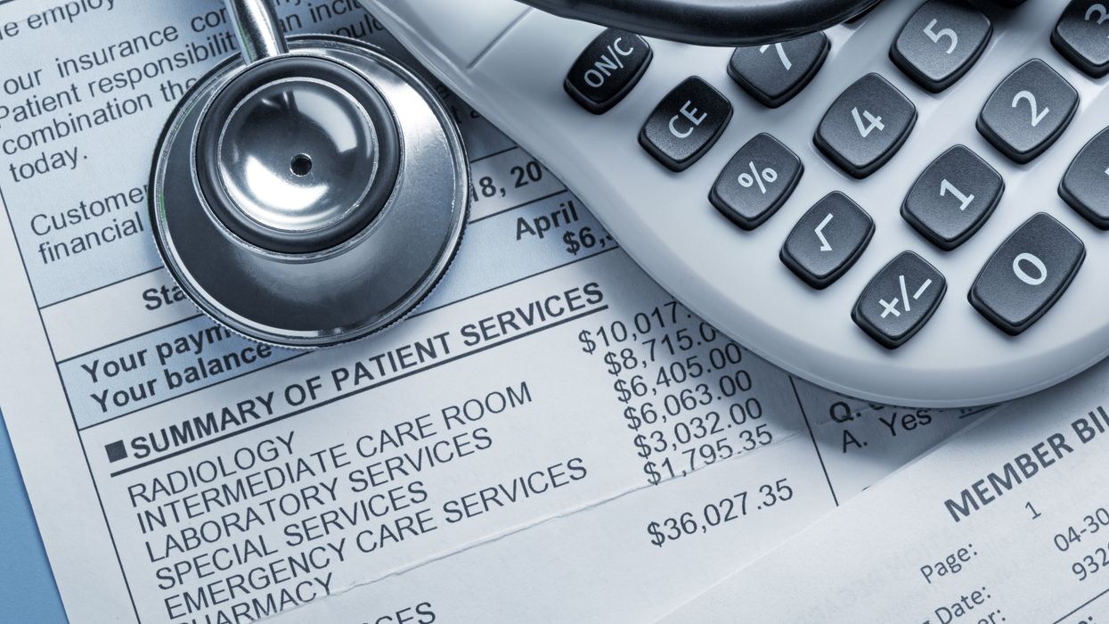 Medical bill, stethoscope, calculator