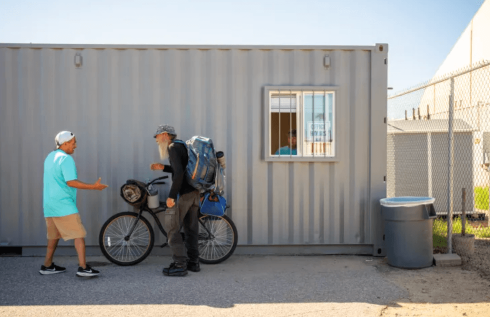 Medina greets a man outside the Keys to Change mail room