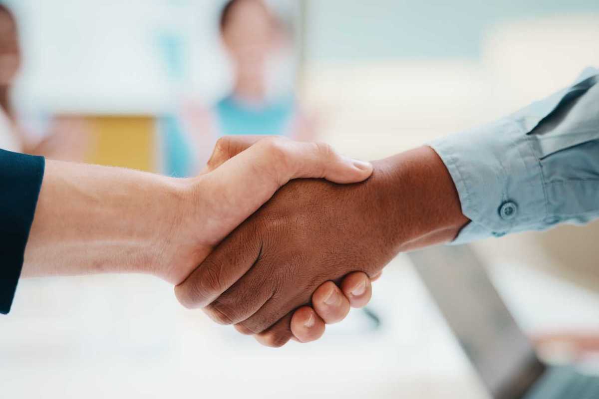 Meeting, handshake and business people with deal in office for funding approval and success.