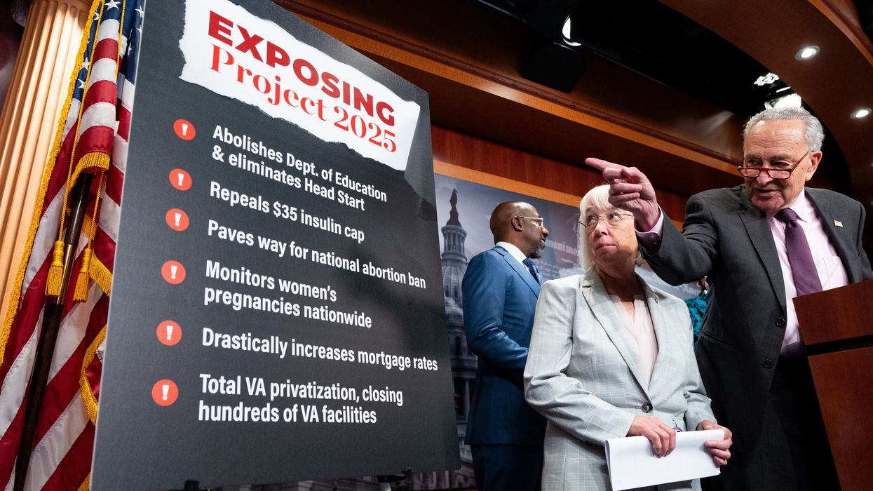 Members of Congress standing next to a poster about Project 2025