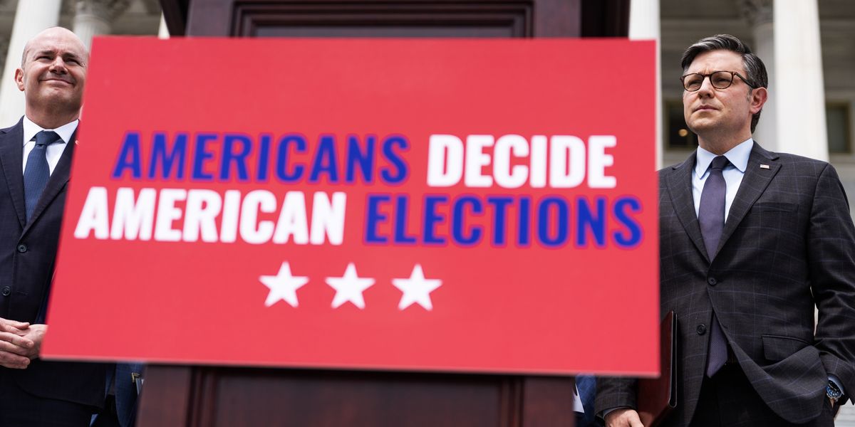 Members of Congress standing next to a sign that reads "Americans Decide American Elections"